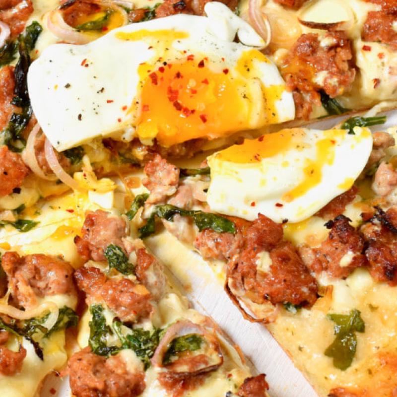 Swaggerty's Farm Sausage Alfredo Pizza topped with an egg