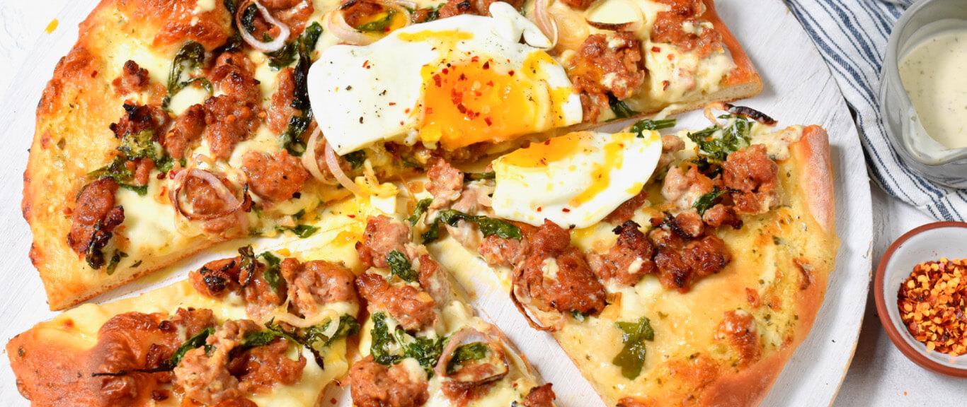 Swaggerty's Farm Sausage Alfredo Pizza topped with an egg